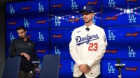 Los Angeles Dodgers general manager Brandon Gomes looks on as right fielder Kyle Tucker (23) is introduced to the media during a press conference at Dodger Stadium.