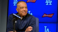 Los Angeles Dodgers manager Dave Roberts (30) answers questions during a news conference at Dodger Stadium.