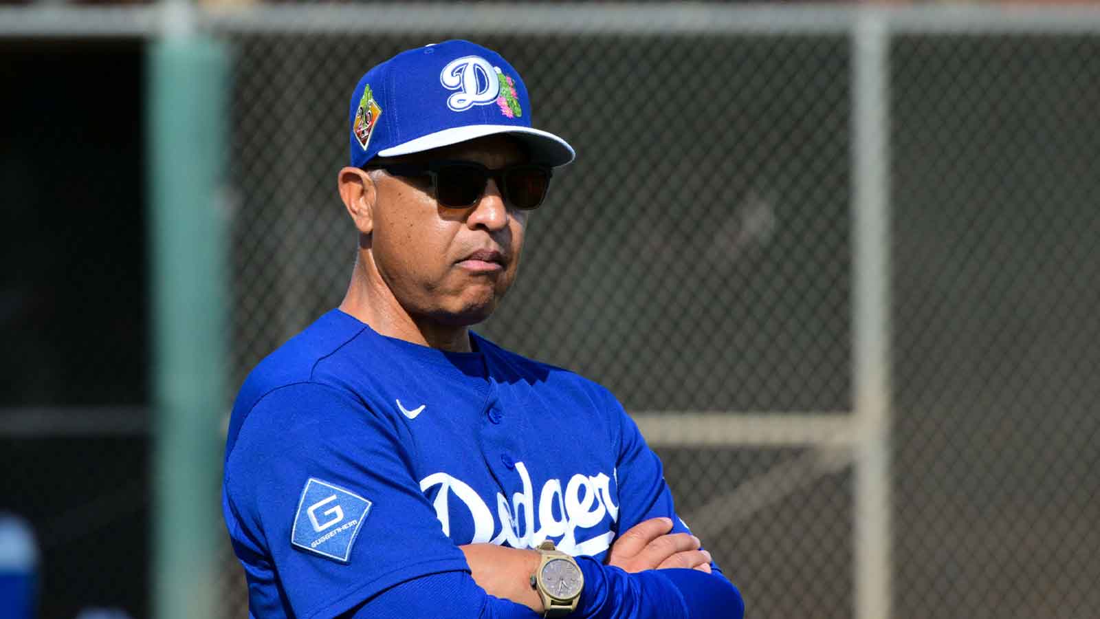 Los Angeles Dodgers manager Dave Roberts (30) looks on during a Spring Training workout at Camelback Ranch.