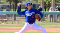 Los Angeles Dodgers two-way player Shohei Ohtani (17) delivers a pitch during a Spring Training workout at Camelback Ranch.