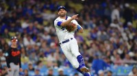 Los Angeles Dodgers third baseman Chris Taylor (3) throws to first for the out against Baltimore Orioles designated hitter Eloy Jimenez (72) during the eighth inning at Dodger Stadium.