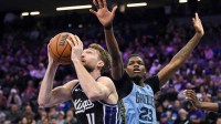 Sacramento Kings forward/center Domantas Sabonis (11) rebounds against Memphis Grizzlies guard Cedric Coward (23) during the third quarter at Golden 1 Center. Mandatory Credit: Ed Szczepanski-Imagn Images