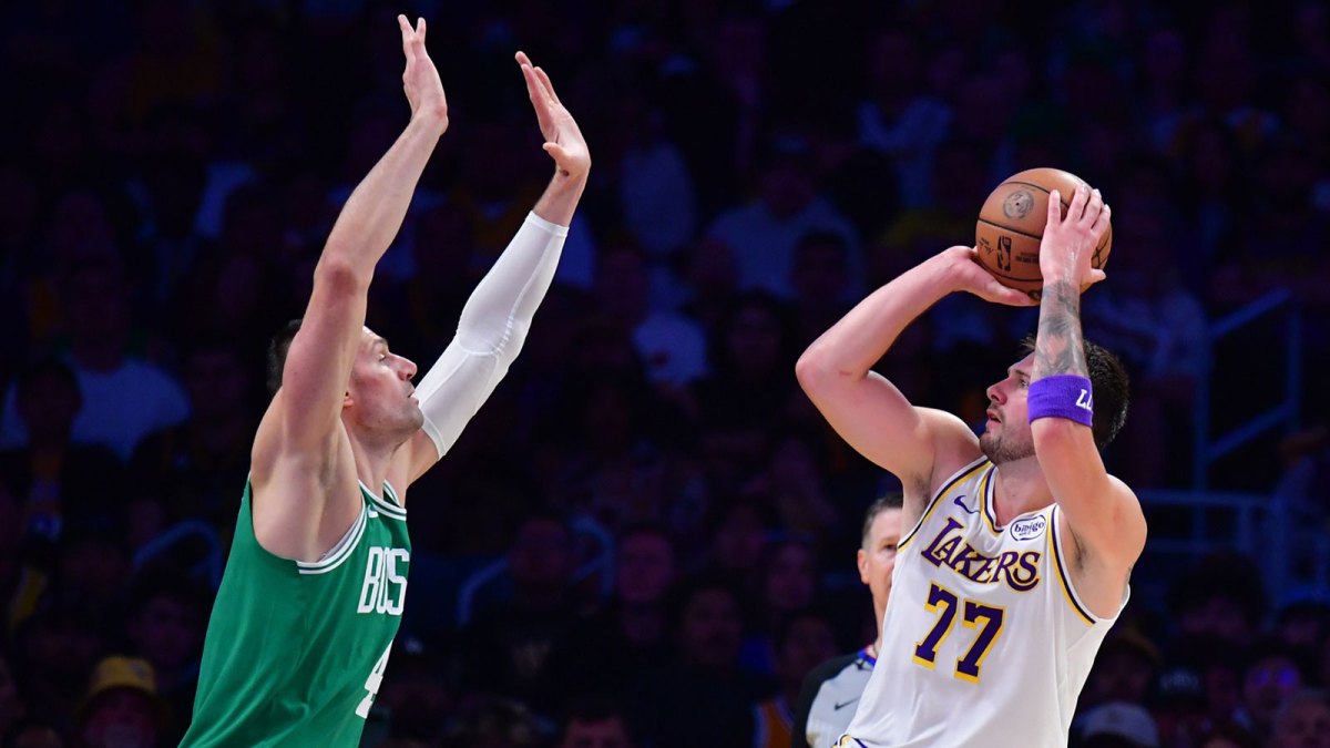 Los Angeles Lakers guard Luka Doncic (77) shoots against Boston Celtics center Nikola Vucevic (4) during the first half at Crypto.com Arena.
