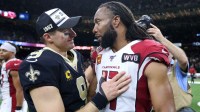 New Orleans Saints quarterback Drew Brees (9) talks to Arizona Cardinals wide receiver Larry Fitzgerald (11) at the end of their game at the Mercedes-Benz Superdome.