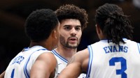 Duke Blue Devils forward Cameron Boozer (12) huddles with teammates Caleb Foster (1) and Isaiah Evans (3) during the first half against the Clemson Tigers at Cameron Indoor Stadium.