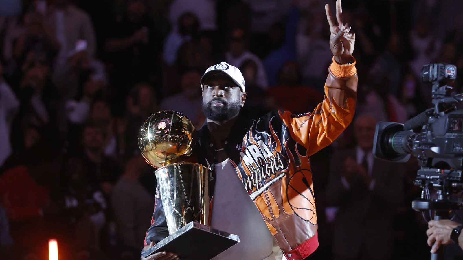 Former Miami Heat guard Dwayne Wade holds the Larry O' Brien trophy during a ceremony to honor 20 years since they won their first NBA Championship during halftime at Kaseya Center.