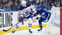 Toronto Maple Leafs right wing William Nylander (88) battles for the puck behind the net with Edmonton Oilers defenseman Alec Regula (75) during the third period at Scotiabank Arena.