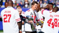 New York Giants former quarterback Eli Manning and head coach Tom Coughlin walk onto the field with the Vince Lombardi Trophy for a ceremony marking the 10 year anniversary of their Super Bowl win in 2011.