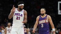 hiladelphia 76ers center Joel Embiid (21) and Phoenix Suns forward Dillon Brooks (3) talk to each other during the second half of an NBA game at Mortgage Matchup Center.