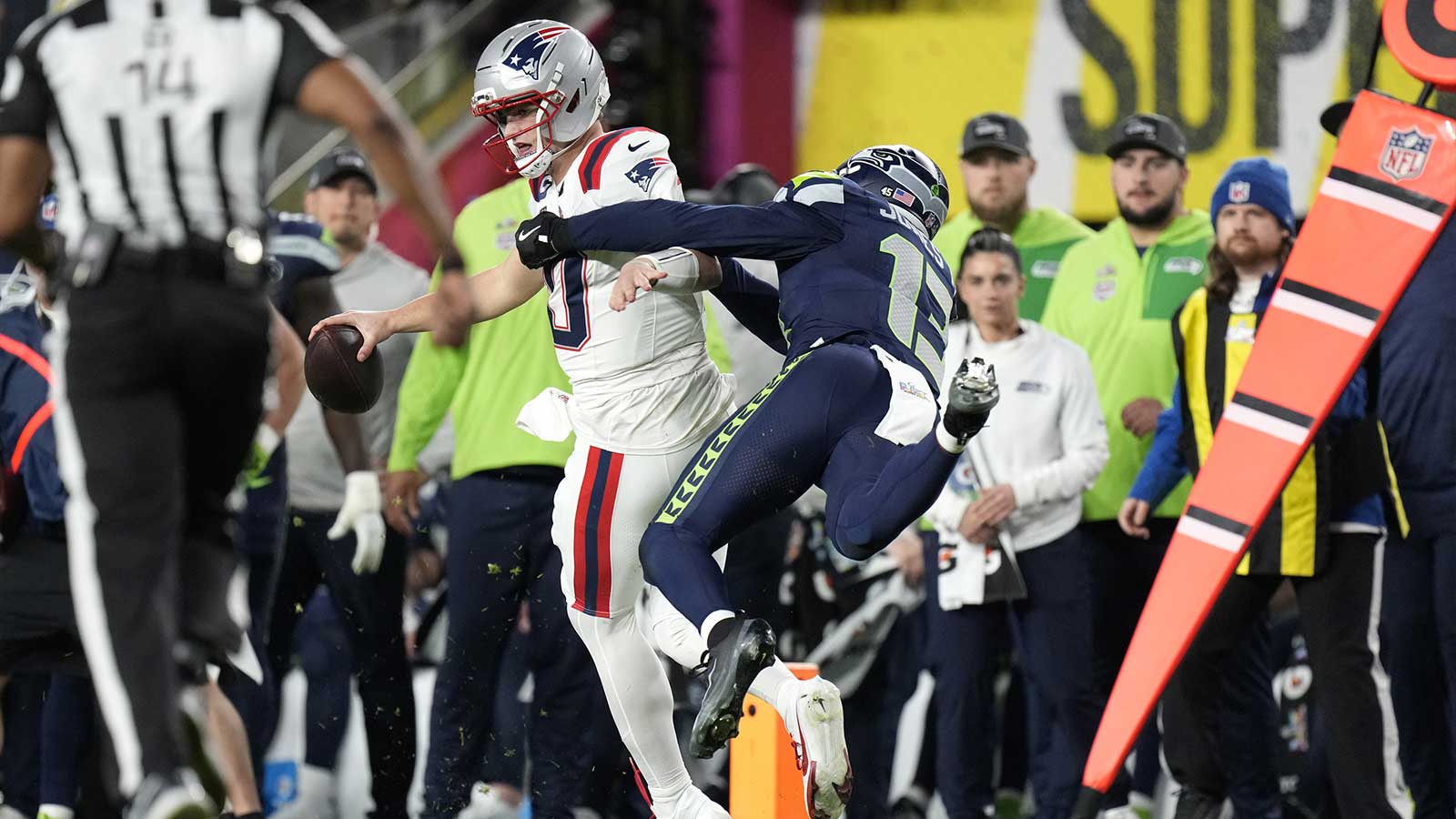 Seattle Seahawks linebacker Ernest Jones IV (13) tackles New England Patriots quarterback Drake Maye (10) during the third quarter in Super Bowl LX at Levi's Stadium.