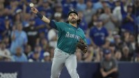 Seattle Mariners third baseman Eugenio Suarez (28) attempts a throw to first against the Toronto Blue Jays in the second inning during game six of the ALCS round for the 2025 MLB playoffs at Rogers Centre.