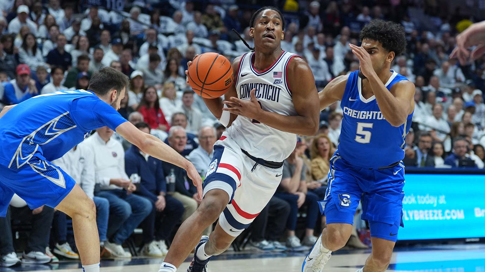 UConn Huskies guard Silas Demary Jr. (2) drives the ball against Creighton Bluejays guard Nik Graves (5) and guard Fedor Žugić (7) in the first half at Harry A. Gampel Pavilion.