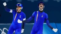 Feb 17, 2026; Milan, Italy; Davide Ghiotto and Michele Malfatti of Italy celebrates after winning the gold medal in the men's team pursuit Final A during the Milano Cortina 2026 Olympic Winter Games at Milano Speed Skating Stadium. Mandatory Credit: Katie Stratman-Imagn Images