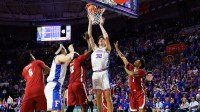 Florida Gators center Olivier Rioux (32) makes a layup over Alabama Crimson Tide forward Aiden Sherrell (22) and Alabama Crimson Tide guard Jalil Bethea (1) during the second half at Exactech Arena at the Stephen C. O'Connell Center.