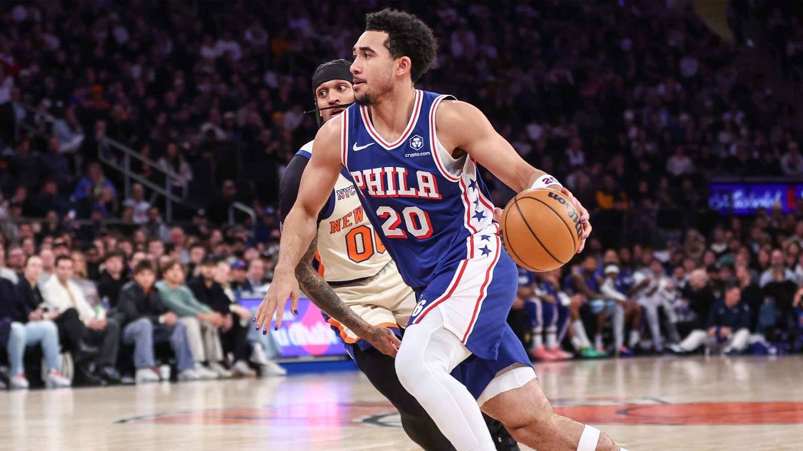 76ers guard Jared McCain (20) drives past New York Knicks guard Jordan Clarkson (00) in the third quarter at Madison Square Garden