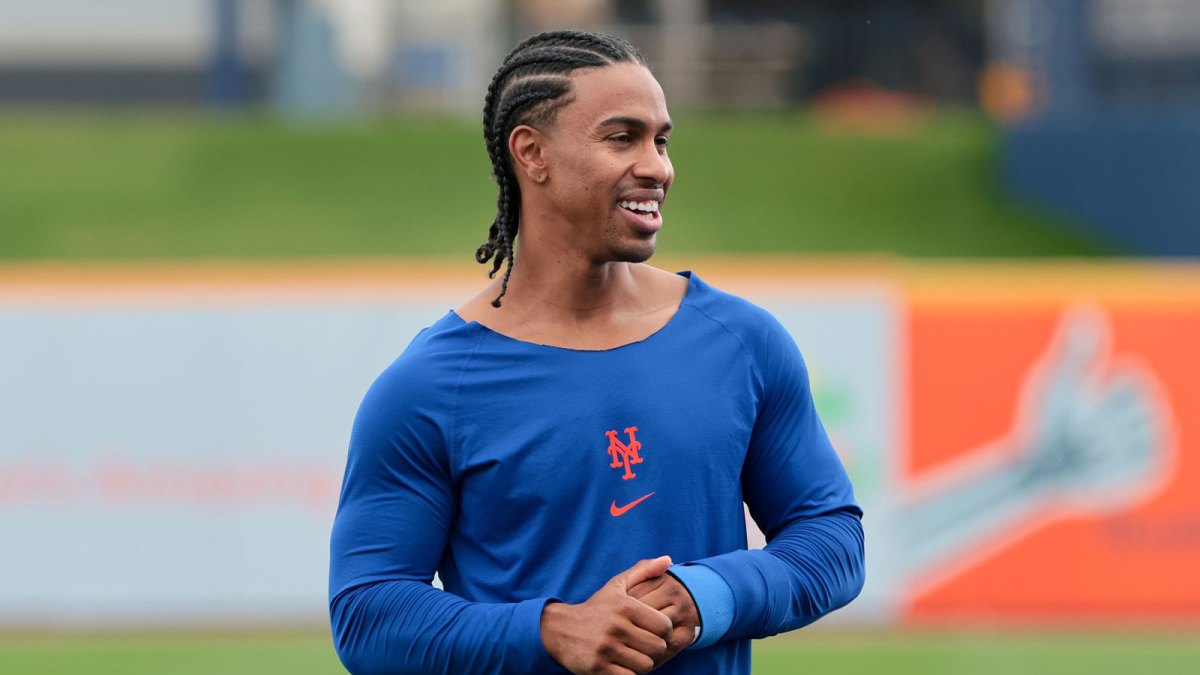 New York Mets infielder Francisco Lindor (12) speaks to bench coach Kai Correa (not pictured) during spring training at Clover Park.