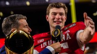 Indiana's Fernando Mendoza (15) talks to the crowd on the podium after the College Football Playoff National Championship college football game at Hard Rock Stadium in Miami Gardens on Monday, Jan. 19, 2026.