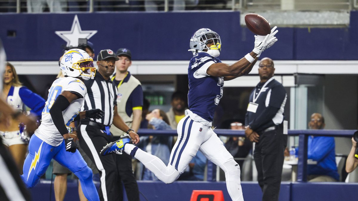 Dallas Cowboys wide receiver George Pickens (3) catches a touchdown pass against Los Angeles Chargers cornerback Cam Hart (20) during the second quarter at AT&T Stadium.