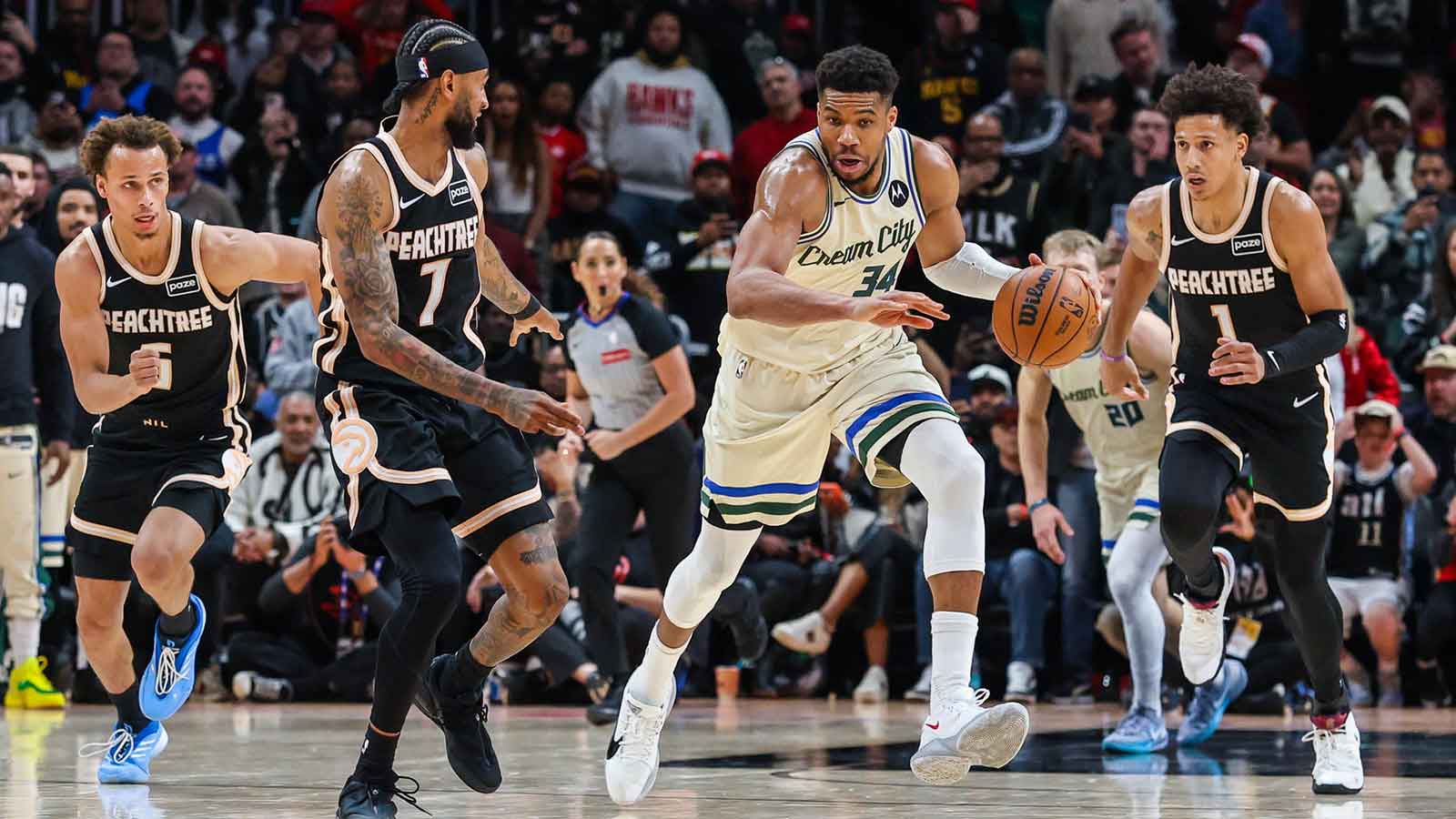 Milwaukee Bucks forward Giannis Antetokounmpo (34) steals the ball against Atlanta Hawks guard Dyson Daniels (5), guard Nickeil Alexander-Walker (7) and forward Jalen Johnson (1) during the fourth quarter at State Farm Arena.