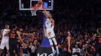 Milwaukee Bucks forward Giannis Antetokounmpo (34) dunks the ball in front of New York Knicks guard Josh Hart (3) during the second half at Madison Square Garden.