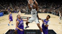 Oct 10, 2025; San Antonio, Texas, USA; San Antonio Spurs forward Harrison Ingram (55) dunks over Utah Jazz forward Kevin Love (42) and guard Ace Bailey (19) during the second half at Frost Bank Center. Mandatory Credit: Scott Wachter-Imagn Images