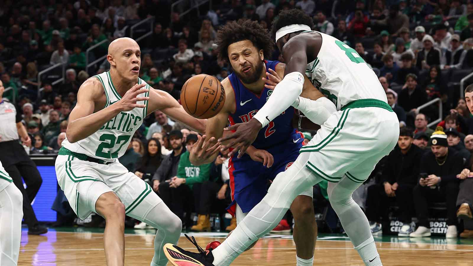 Detroit Pistons guard Cade Cunningham (2) looses the ball trying to go between Boston Celtics guard Jordan Walsh (27) and center Neemias Queta (88) during the first quarter at TD Garden.