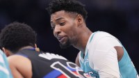 Charlotte Hornets forward Brandon Miller (24) talks to Detroit Pistons guard Daniss Jenkins (24) during a free throw during the second half at Spectrum Center.