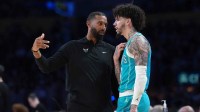 Hornets head coach Charles Lee (left) talks with guard LaMelo Ball (1) against the Los Angeles Lakers in the second half at Crypto.com Arena