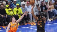 Cleveland Cavaliers guard Donovan Mitchell (45) shoots against Charlotte Hornets guard Kon Knueppel (7) during the second half at the Spectrum Center.