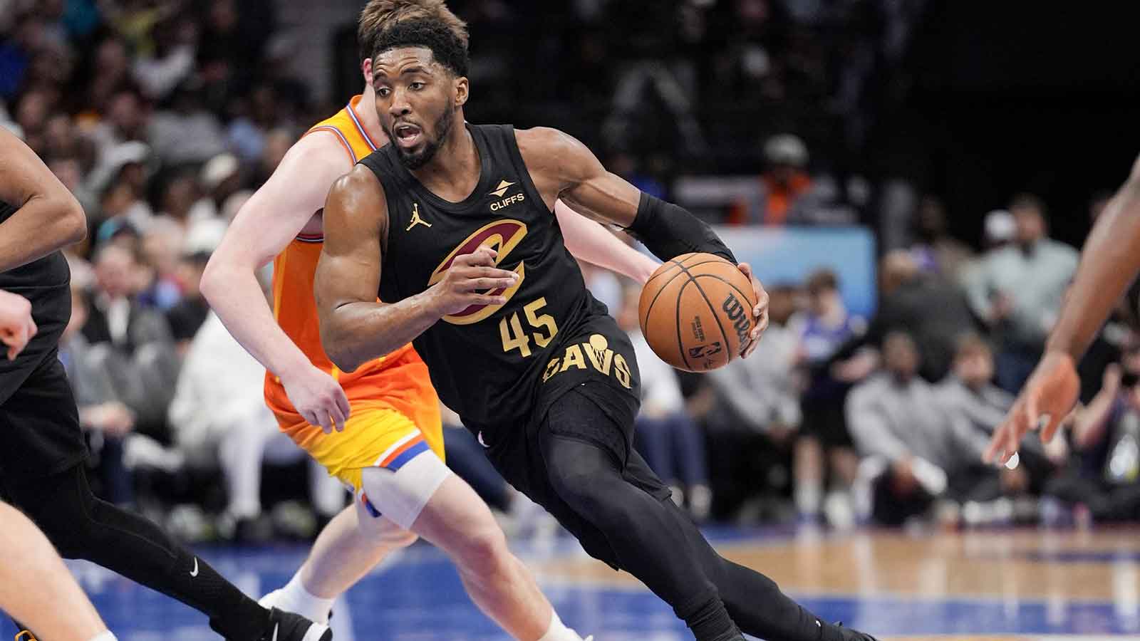 Cleveland Cavaliers guard Donovan Mitchell (45) drives against Charlotte Hornets guard Kon Knueppel (7) during the second half at the Spectrum Center.