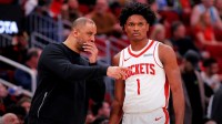 Houston Rockets head coach Ime Udoka talks with Houston Rockets guard Amen Thompson (1) against the Charlotte Hornets during the third quarter at Toyota Center.
