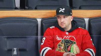 Chicago Cubs third baseman Alex Bregman watches an NHL game between the Chicago Blackhawks and Edmonton Oilers during the third period at United Center.