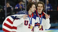 Quinn Hughes (43) of the United States and Jack Hughes (86) of the United States celebrate after defeating Canada in the men's ice hockey gold medal game during the Milano Cortina 2026 Olympic Winter Games at Milano Santagiulia Ice Hockey Arena