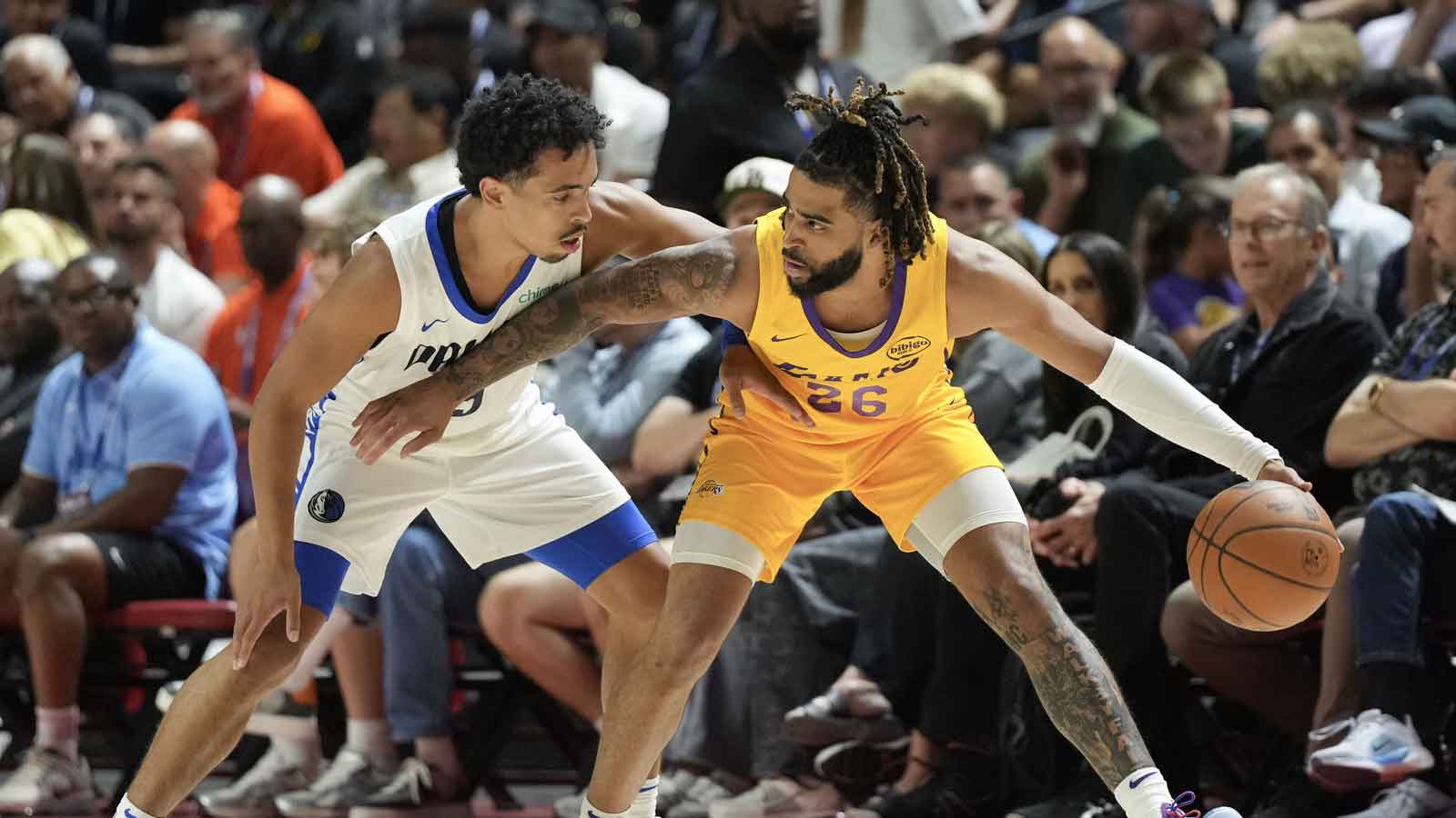 Los Angeles Lakers guard RJ Davis (26) dribbles against Dallas Mavericks guard Ryan Nembhard (9) in the first quarter of their game at Thomas & Mack Center.