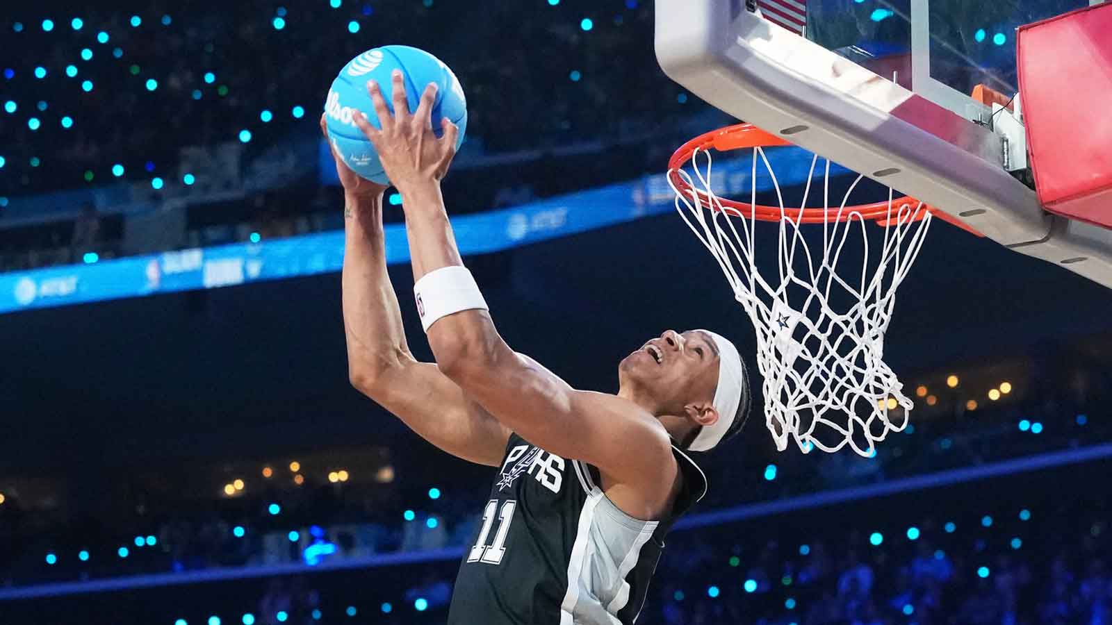 San Antonio Spurs forward Carter Bryant (11) competes in the slam dunk contest during the 2026 NBA All Star Saturday Night at Intuit Dome.