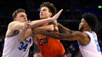 Illinois guard Keaton Wagler (23) tries to drive to the basket between UCLA forward Tyler Bilodeau (34) and UCLA guard Donovan Dent (2) during the second half at Pauley Pavilion presented by Wescom Financial.