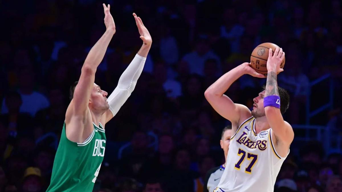 Los Angeles Lakers guard Luka Doncic (77) shoots against Boston Celtics center Nikola Vucevic (4) during the first half at Crypto.com Arena.