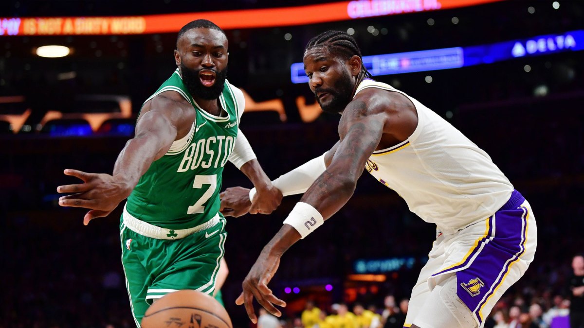 Feb 22, 2026; Los Angeles, California, USA; Boston Celtics guard Jaylen Brown (7) and Los Angeles Lakers center Deandre Ayton (5) play for the ball during the second half at Crypto.com Arena.
