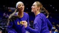 LSU Lady Tigers forward Angel Reese, left, and guard Izzy Besselman practice a handshake celebration routine that ends with air kisses before a game against the Florida Gators at Pete Maravich Assembly Center.