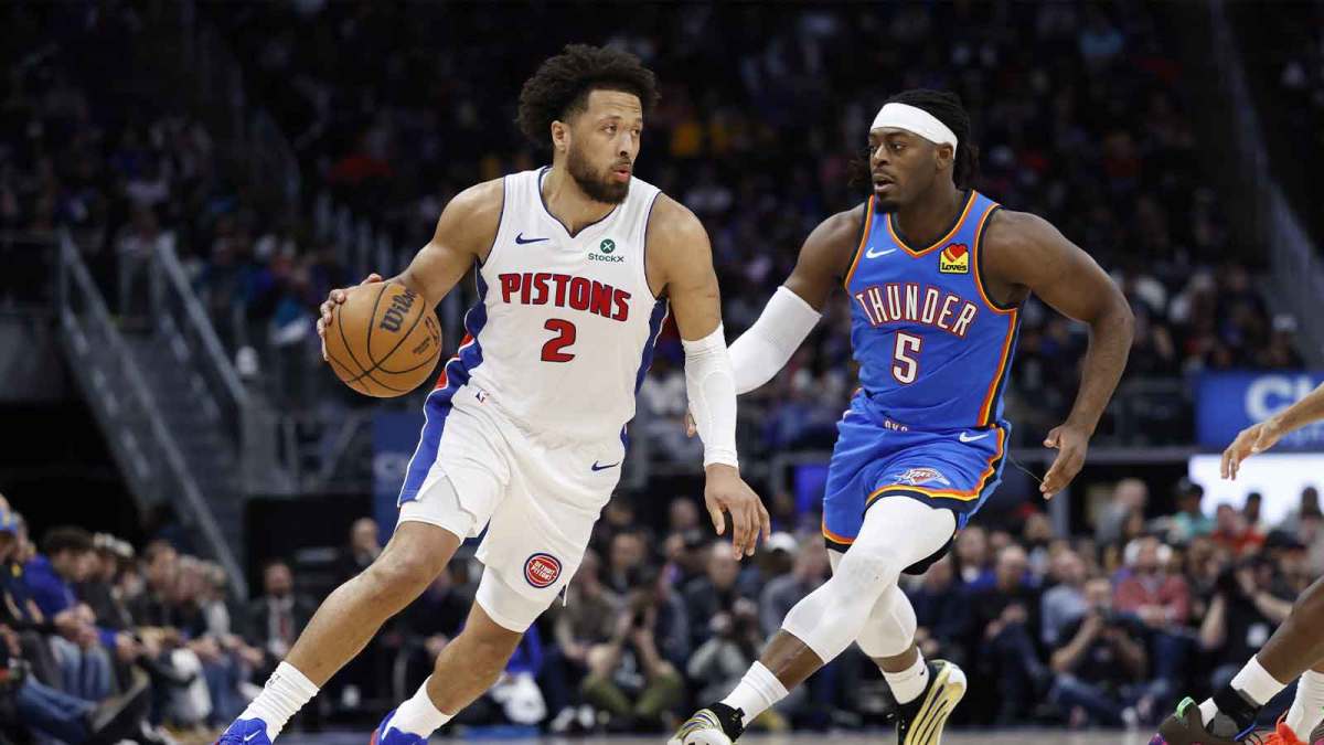 Detroit Pistons guard Cade Cunningham (2) dribbles on Oklahoma City Thunder guard Luguentz Dort (5) in the first half at Little Caesars Arena.