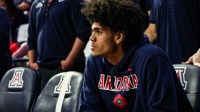 Arizona Wildcats forward Koa Peat (10) sides on the bench with an injury before the start of the game against the Brigham Young Cougars at McKale Memorial Center.
