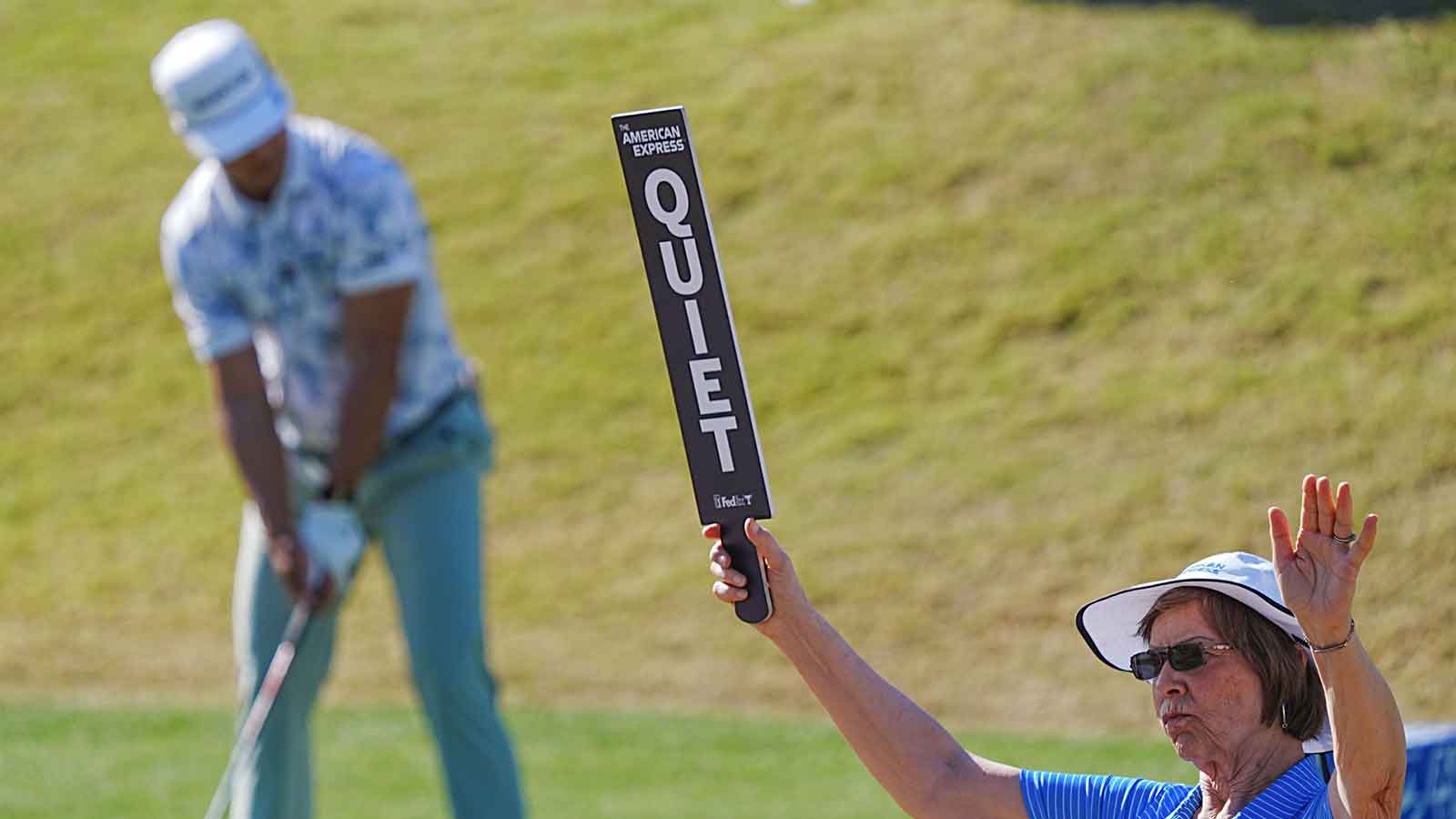 A volunteer keeps the gallery quiet as Isaiah Salinda tees off on the 10th during the second round of the American Express at PGA West in La Quinta, January 23, 2026.