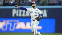 Toronto Blue Jays second baseman Isiah Kiner-Falefa (7) throws to first for an out against Los Angeles Dodgers two-way player Shohei Ohtani (17) in the eleventh inning during game seven of the 2025 MLB World Series at Rogers Centre.