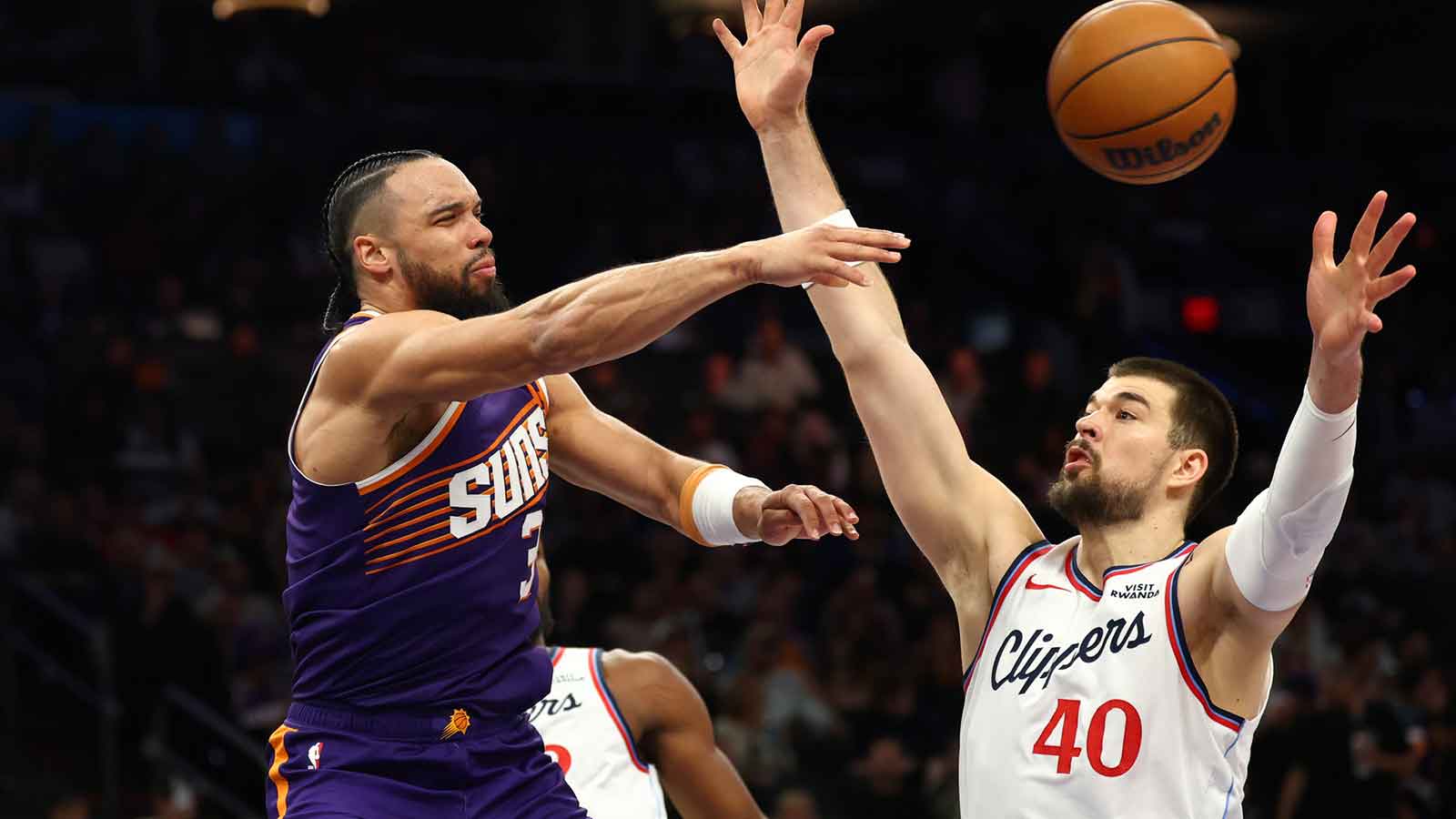 Phoenix Suns forward Dillon Brooks (3) passes the ball to Los Angeles Clippers center Ivica Zubac (40) in the second half at the Mortgage Matchup Center. Mandatory Credit: Mark J. Rebilas-Imagn Images