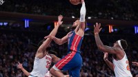 Detroit Pistons guard Cade Cunningham (2) goes up for a dunk against New York Knicks center Karl-Anthony Towns (32) during the second half at Madison Square Garden.