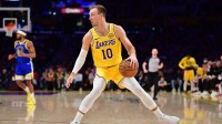 Los Angeles Lakers guard Luke Kennard (10) controls the ball against the Golden State Warriors during the first half at Crypto.com Arena. Mandatory Credit: Gary A. Vasquez-Imagn Images