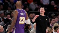 Los Angeles Lakers head coach JJ Redick talks to forward LeBron James (23) during the first quarter against the New York Knicks at Madison Square Garden.