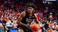 Texas Tech Red Raiders forward JT Toppin (15) dribbles and dunks the ball during the first half of the game against the Arizona Wildcats at McKale Memorial Center.
