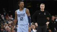 Memphis Grizzlies guard Ja Morant (12) and head coach Tuomas Iisalo looks on during the third quarter against the Atlanta Hawks at FedExForum.