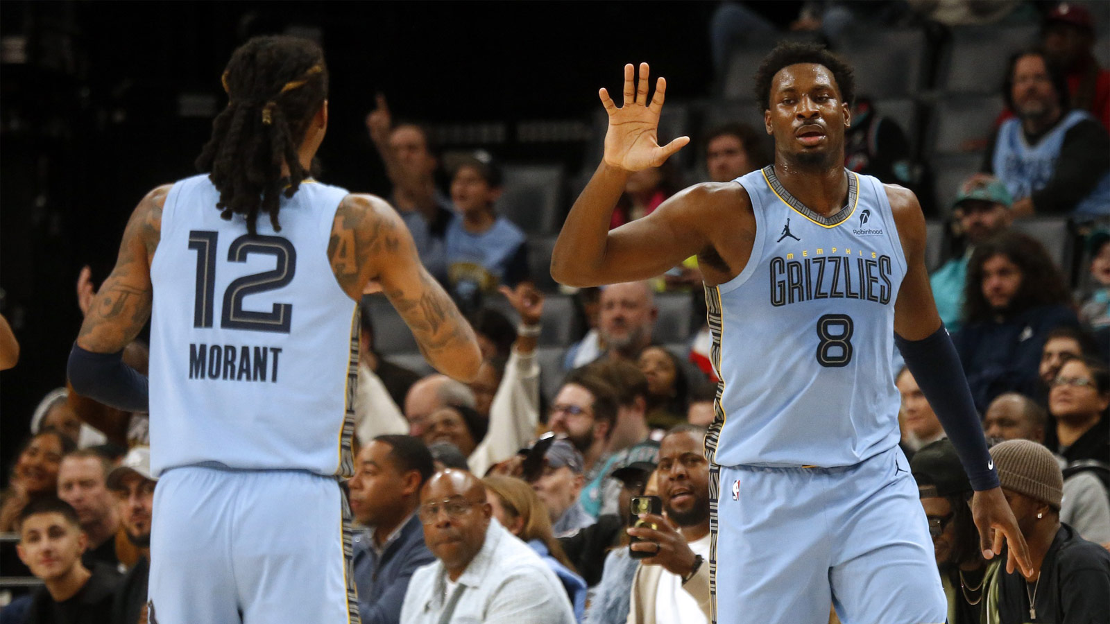 Memphis Grizzlies forward Jaren Jackson Jr. (8) reacts with guard Ja Morant (12) during the first quarter against the Atlanta Hawks at the FedExForum. 